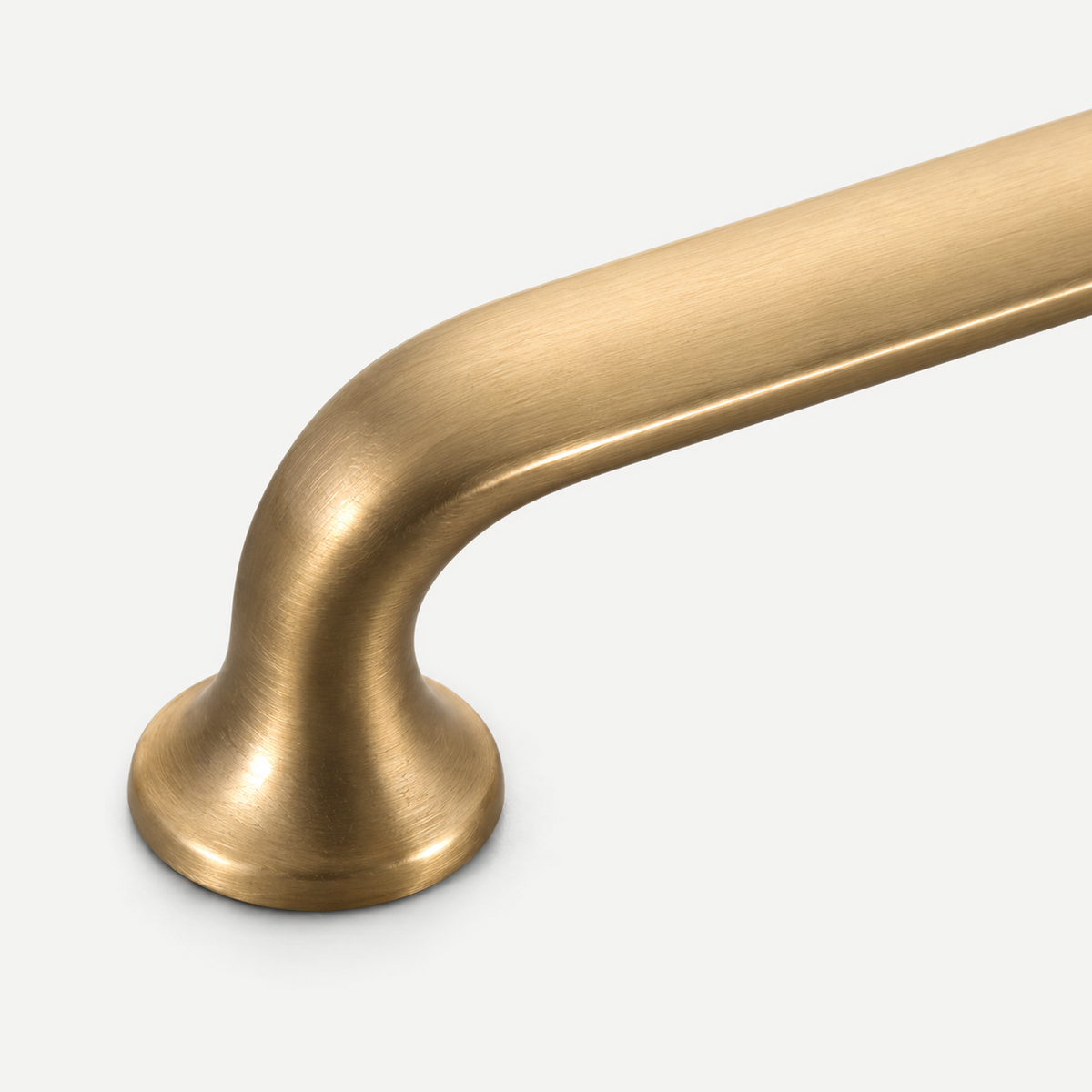Brushed brass cabinet hardware - Curved grip to integral flared mounting foot detail