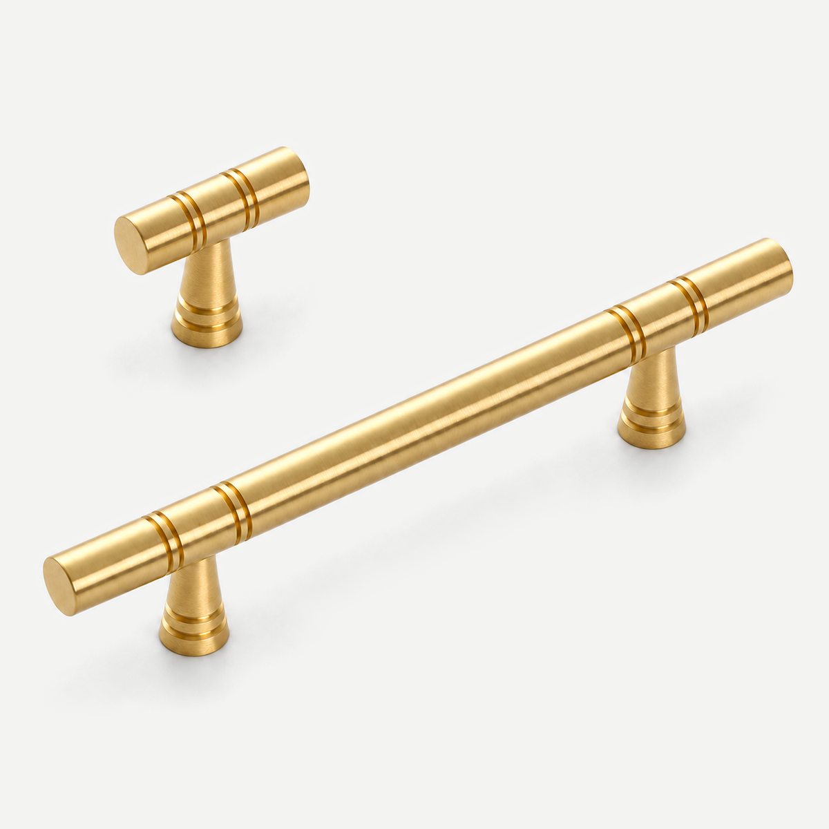Brushed brass 128mm cabinet pull and 50mm T knob, representative pair on pale grey