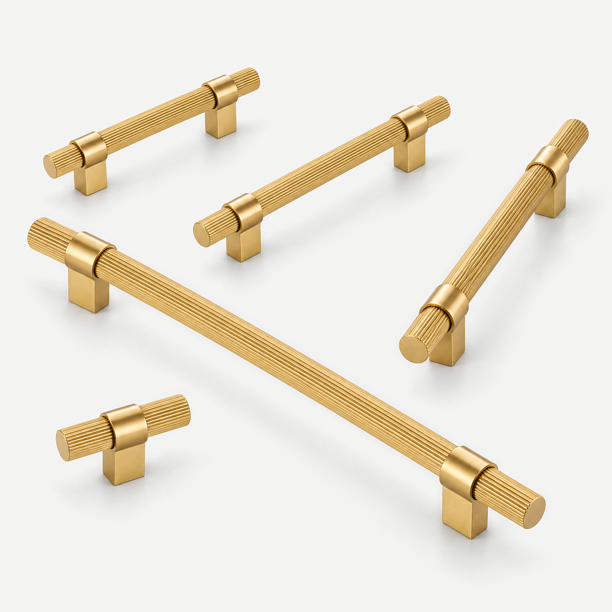 Longitudinally fluted brushed brass handles with rectangular feet — four pull sizes and T knob in an open fan arrangement