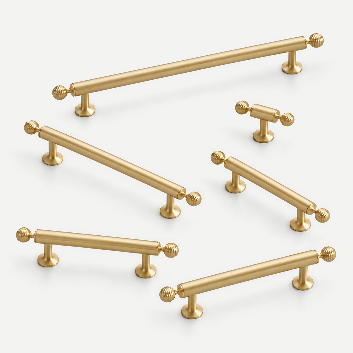 Finial brass cabinet handles - all six actual sizes in a natural studio arrangement