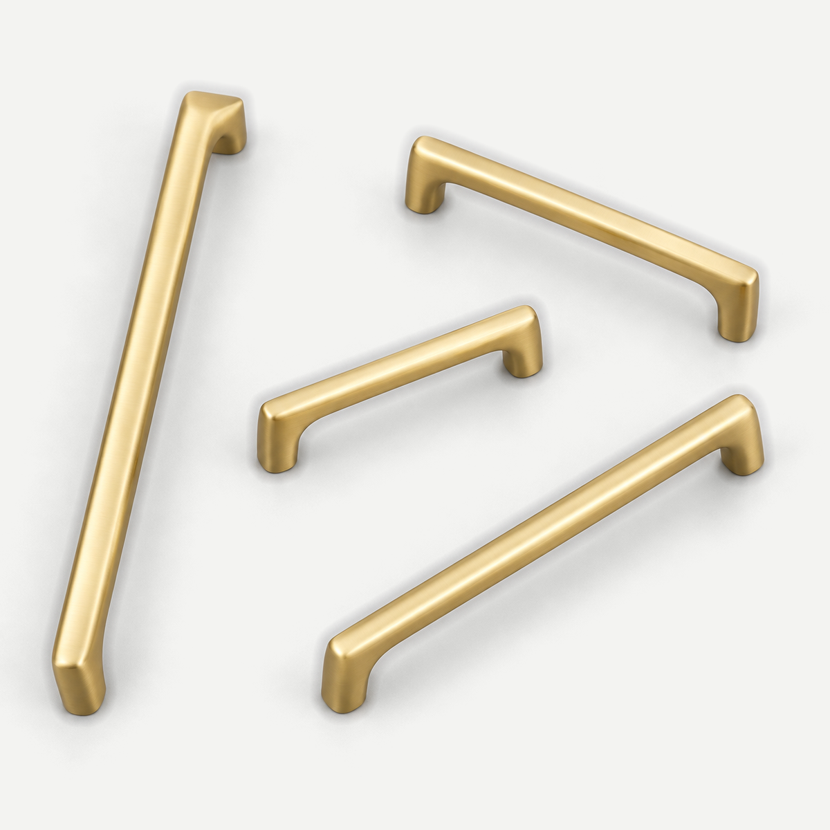 Brushed brass D pulls - four sizes in an asymmetrical arrangement