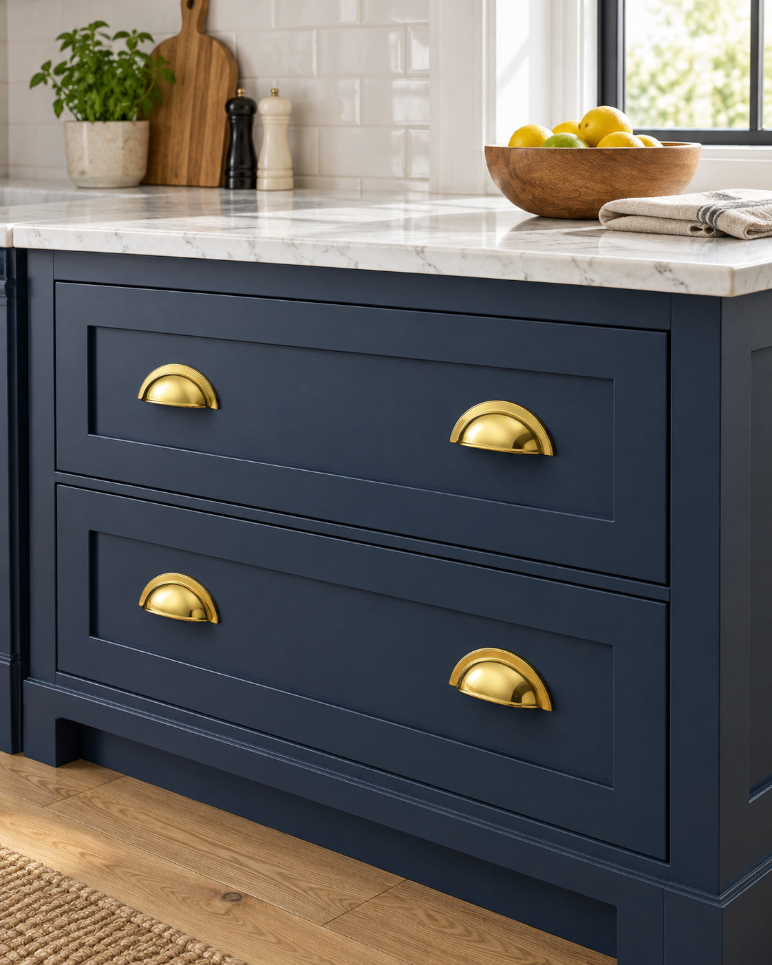Brass cup pulls on deep blue kitchen drawers